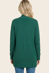 woman wearing a green long sleeve cardigan sweater, shown from the back with a relaxed fit and ribbed texture