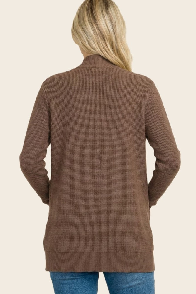 woman wearing a brown ribbed long sleeve cardigan, viewed from the back