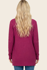 woman wearing a long-sleeve magenta sweater, view from the back, with loose fit and textured fabric