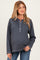 woman wearing a dark gray maternity long sleeve henley top with a button placket and relaxed fit, showing a baby bump