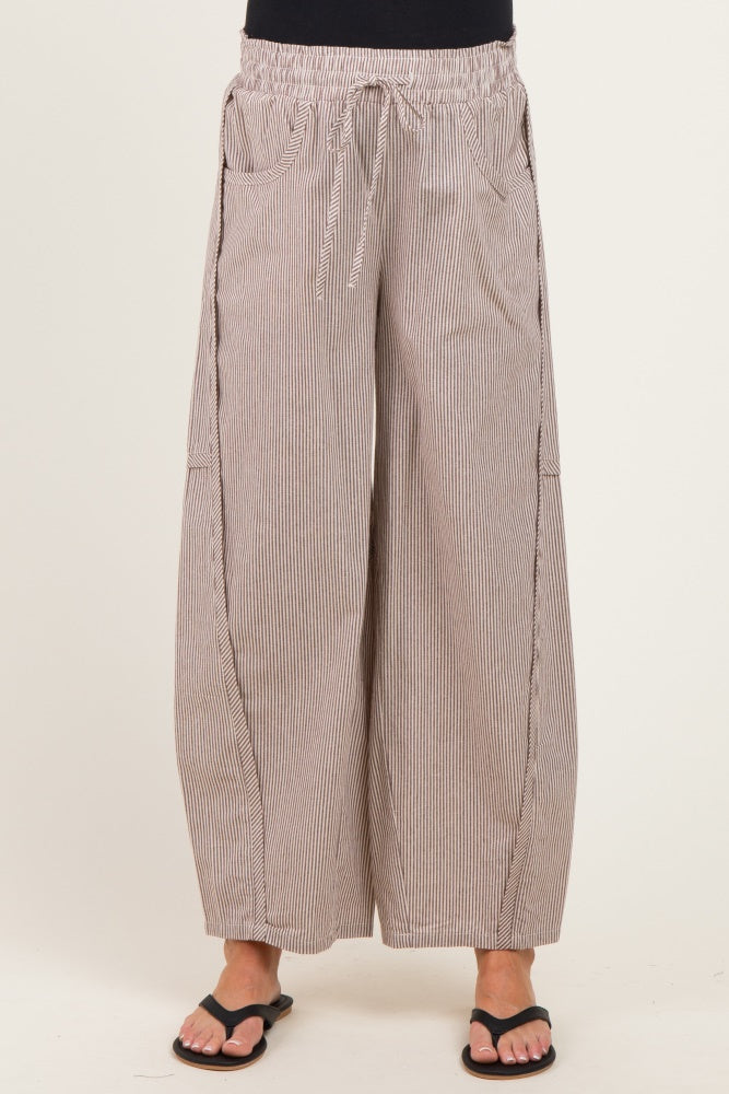 woman wearing wide-leg striped maternity pants with an elastic waistband and side pockets