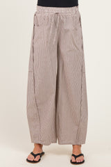 woman wearing wide-leg striped maternity pants with an elastic waistband and side pockets