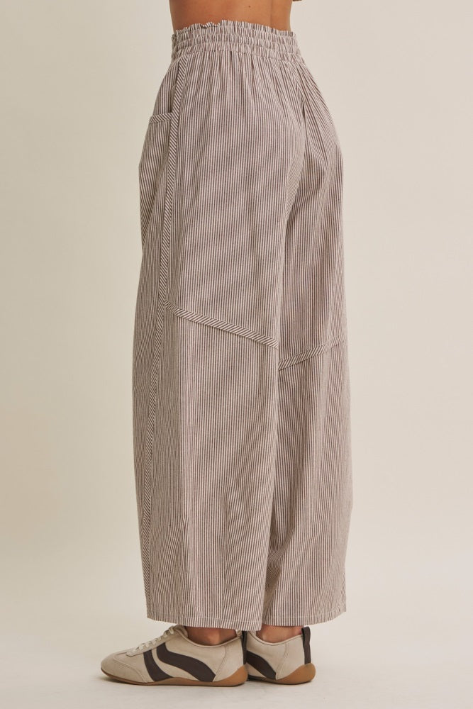 woman wearing loose-fitting striped wide-leg pants with an elastic waistband and side pockets