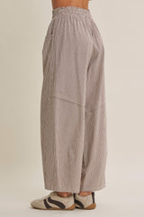 woman wearing loose-fitting striped wide-leg pants with an elastic waistband and side pockets