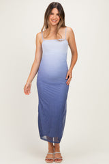 woman wearing a blue ombre maternity maxi dress with spaghetti straps and a fitted silhouette, showing her baby bump