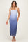 woman wearing a blue ombre maternity maxi dress with spaghetti straps and a fitted silhouette, showing her baby bump
