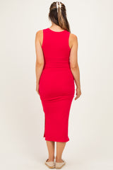 woman wearing a red tank top midi maternity dress with side slits and a fitted silhouette