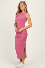 woman wearing a pink ribbed maxi dress with side ruching and a thigh-high slit, paired with white sneakers