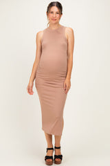 woman wearing a dusty pink ribbed maternity midi dress with side ruching and a visible baby bump