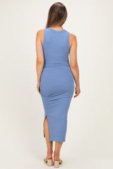 woman wearing a light blue sleeveless maternity dress with ruched sides and a high slit on the back