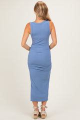 woman wearing a blue ribbed midi dress with ruched sides, viewed from the back