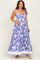 woman wearing a purple floral maternity maxi dress and holding her baby bump