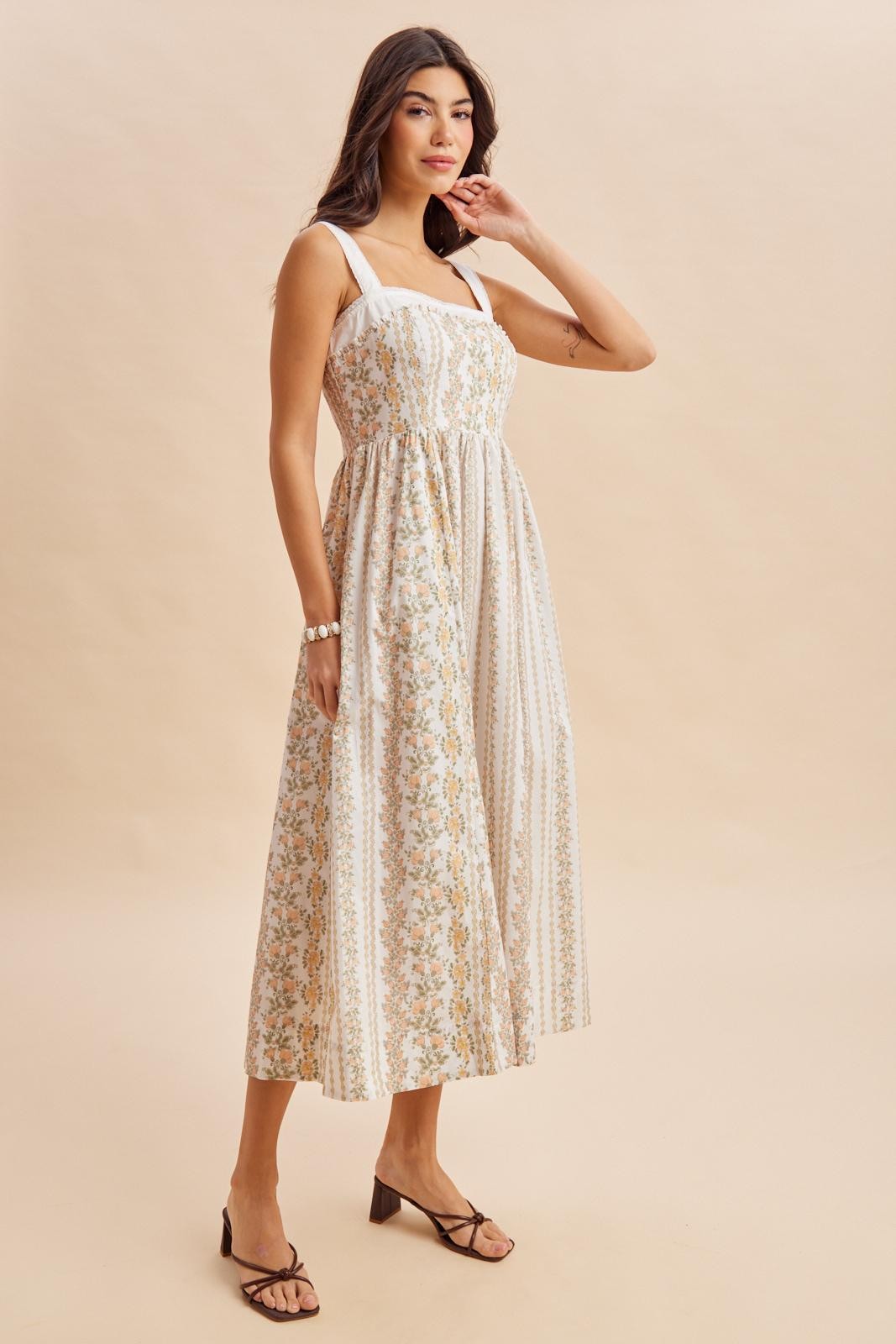 woman wearing a floral patterned midi dress with square neckline and adjustable straps