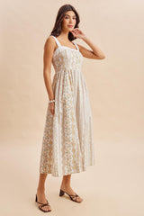 woman wearing a floral patterned midi dress with square neckline and adjustable straps