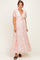 woman wearing a floral maternity maxi dress with short sleeves and a tie detail at the bust, showing her baby bump