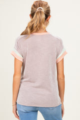 woman wearing a striped maternity top with short sleeves and a relaxed fit, seen from the back