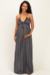 woman wearing a striped maxi maternity dress with a tie front detail and showing her baby bump