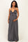 woman wearing a striped maxi maternity dress with a tie front detail and showing her baby bump
