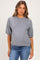 woman wearing a gray short sleeve maternity sweater and blue jeans