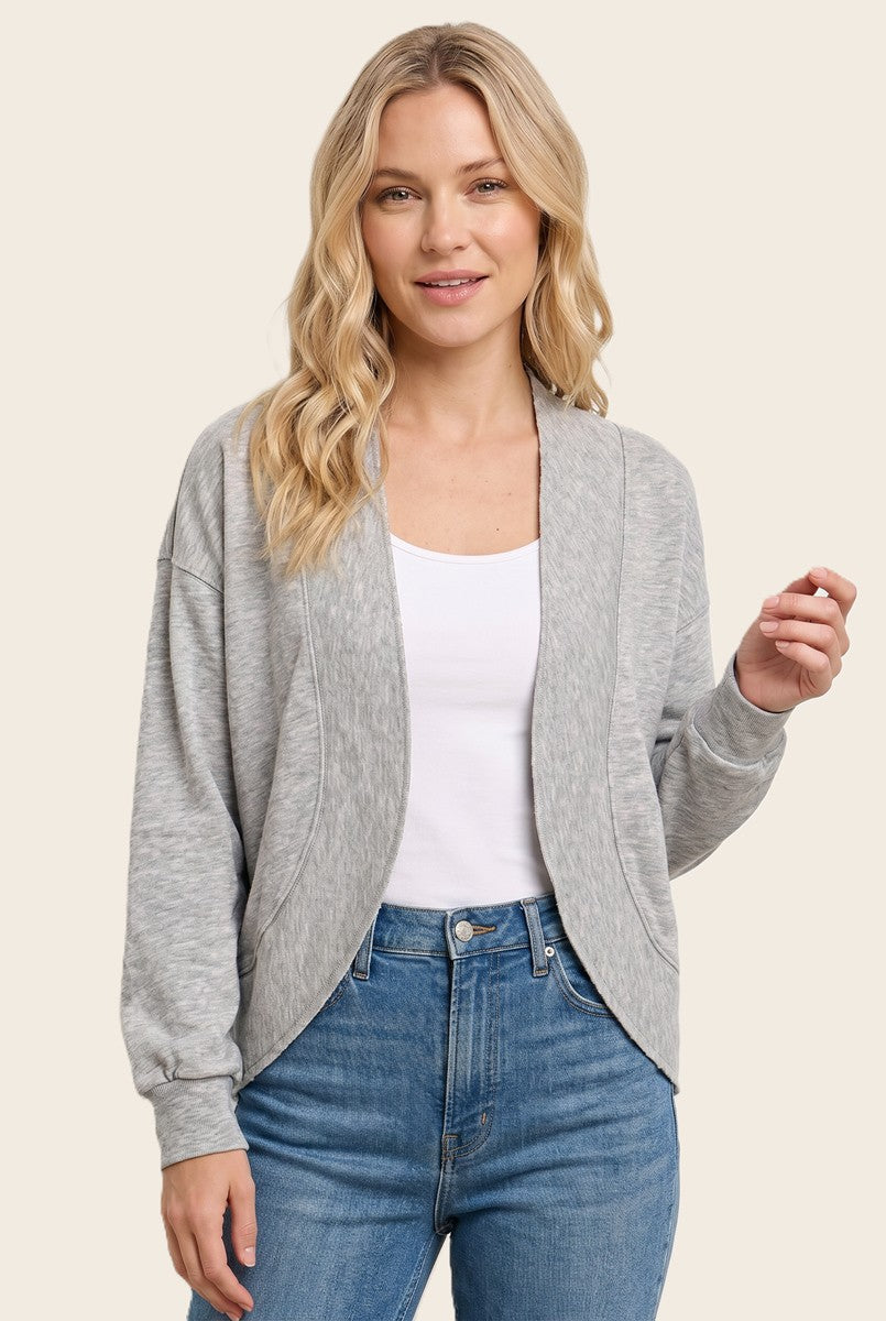woman wearing a gray open-front cardigan over a white t-shirt and blue jeans