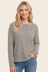 woman wearing a black and cream striped long sleeve top with a relaxed fit and round neckline
