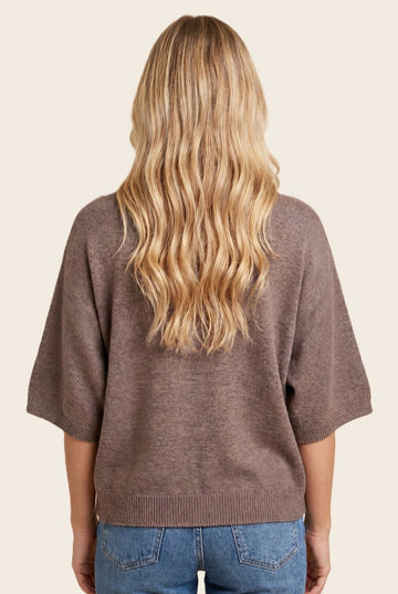 woman wearing a brown oversized sweater with short sleeves, seen from the back