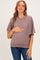 woman wearing a mauve short sleeve maternity sweater and holding her baby bump
