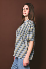 woman wearing a striped oversized t-shirt with short sleeves paired with high-waisted denim jeans