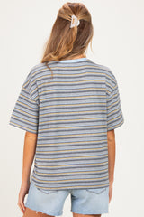 woman wearing a striped oversized maternity t-shirt with short sleeves and light blue denim shorts, showing her back
