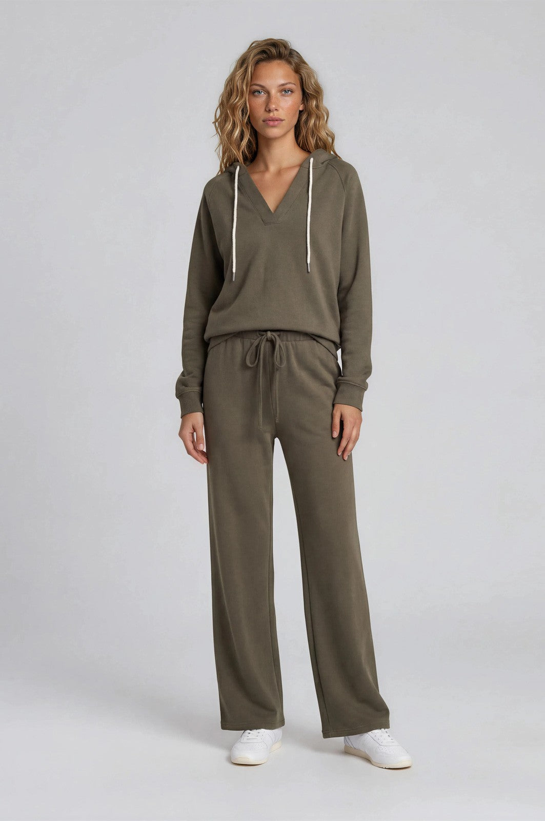 woman wearing a relaxed olive green hoodie and matching wide-leg pants with a drawstring waist