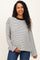 woman wearing a striped black and white maternity sweater with long sleeves and a relaxed fit, holding her baby bump