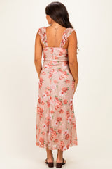 woman wearing a floral maternity dress with ruffled straps and a fitted bodice, showing a baby bump from the back