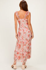 woman wearing a floral maxi dress with ruffled straps and a fitted bodice, shown from the back