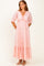 woman wearing a pink lace maxi dress with a v-neckline and puff sleeves