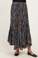 maternity wear floral maxi skirt with a deep blue and burgundy pattern, model wearing black flats and showcasing a flowy silhouette