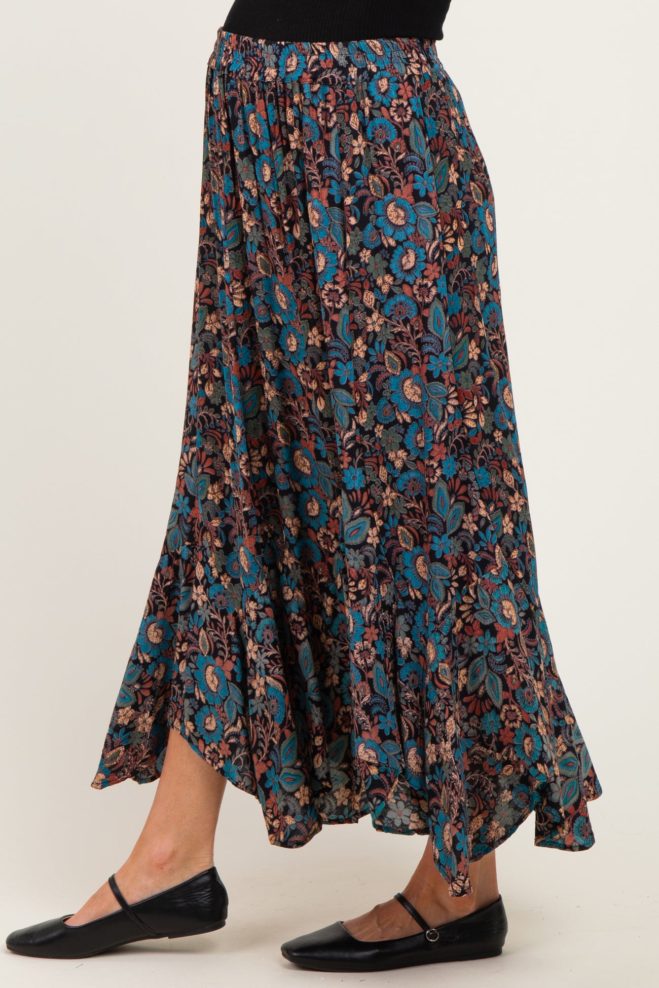 woman wearing a floral pattern maternity maxi skirt with a relaxed fit and flared hem