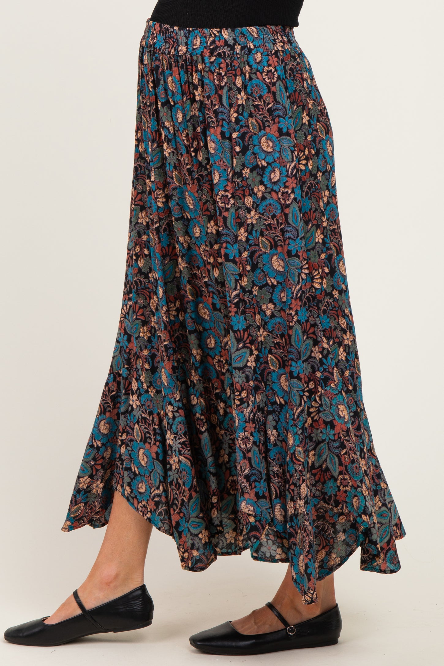 woman wearing a floral pattern maternity maxi skirt with a relaxed fit and flared hem