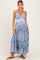 woman wearing a blue and white patterned maternity maxi dress with a deep v-neck and adjustable straps, showcasing her baby bump