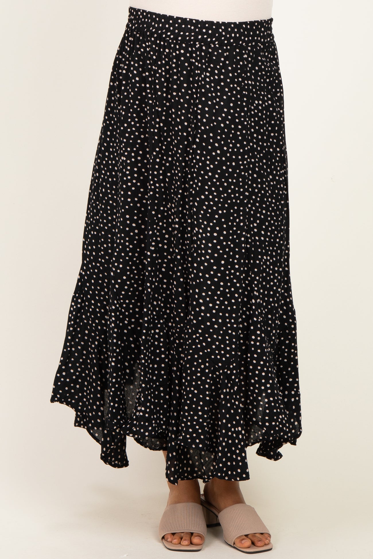 maternity wear black and white polka dot maxi skirt with ruffled hem, worn by a model