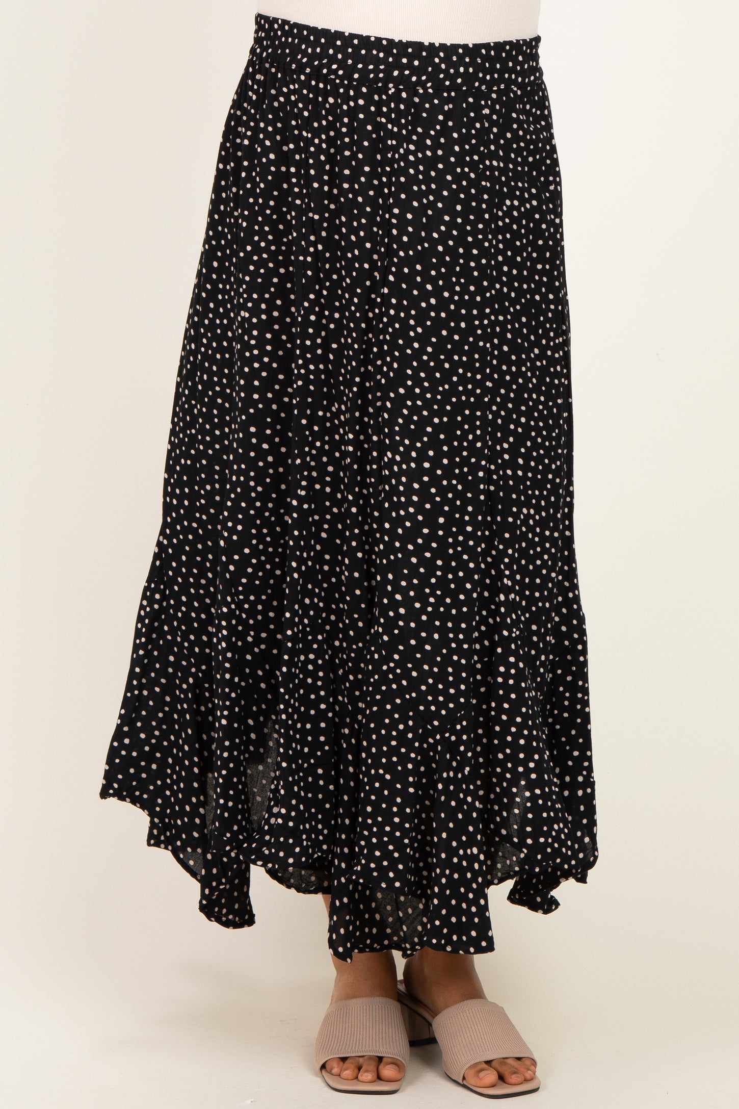 maternity wear black and white polka dot maxi skirt with ruffled hem, worn by a model