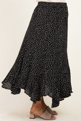 maternity wear black polka dot midi skirt with a flowing ruffle hem, styled with a pair of beige block-heeled sandals