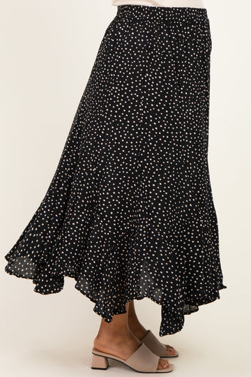 maternity wear black polka dot midi skirt with a flowing ruffle hem, styled with a pair of beige block-heeled sandals