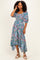 woman wearing a floral print midi dress with puff sleeves and a high-low hemline
