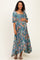 woman wearing a floral maternity maxi dress with a square neckline and puff sleeves, holding her baby bump