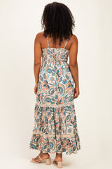 woman wearing a floral print maxi dress with smocked bodice and tiered skirt, shown from the back