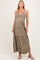 woman wearing a floral olive green maternity maxi dress with a knot detail and a visible baby bump
