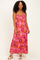 woman wearing a pink floral maxi dress with spaghetti straps and a tiered skirt