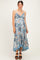 woman wearing a floral print maternity maxi dress with spaghetti straps and a flowing hem, showing her baby bump
