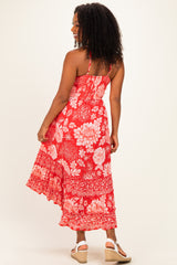 woman wearing a red floral maxi dress with adjustable straps and a ruffled hem, seen from the back