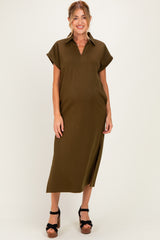 woman wearing a dark olive green short sleeve maternity dress with a collar and side slit